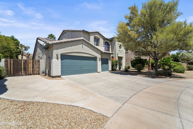 14430 W Windsor Ave, Goodyear, AZ 85395 - view of front of home featuring concrete driveway, stucco siding, an attached garage, a tiled roof, and fence