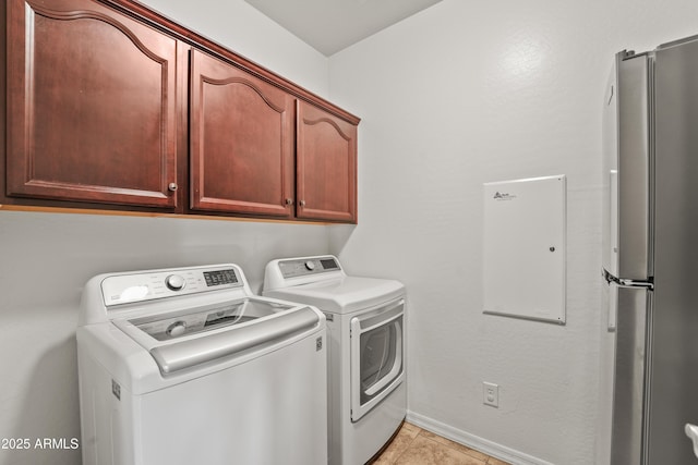 14430 W Windsor Ave, Goodyear, AZ 85395 - clothes washing area with washing machine and dryer, light tile patterned floors, cabinet space, and baseboards