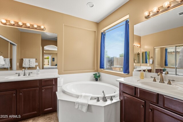 14430 W Windsor Ave, Goodyear, AZ 85395 - full bathroom featuring two vanities, a bath, and tile patterned flooring