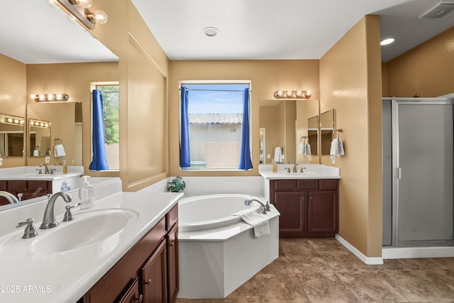 14430 W Windsor Ave, Goodyear, AZ 85395 - bathroom featuring a stall shower, a bath, two vanities, and tile patterned floors