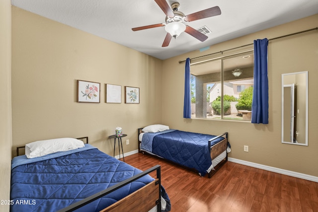 14430 W Windsor Ave, Goodyear, AZ 85395 - bedroom with wood finished floors, baseboards, and a ceiling fan