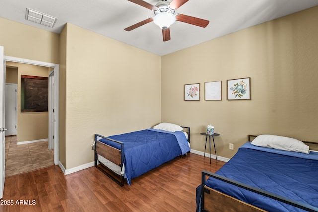 14430 W Windsor Ave, Goodyear, AZ 85395 - bedroom with wood finished floors, baseboards, and a ceiling fan