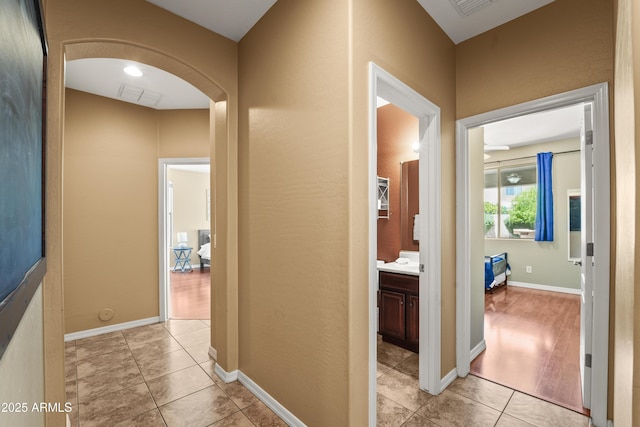 14430 W Windsor Ave, Goodyear, AZ 85395 - hallway featuring arched walkways and light tile patterned floors