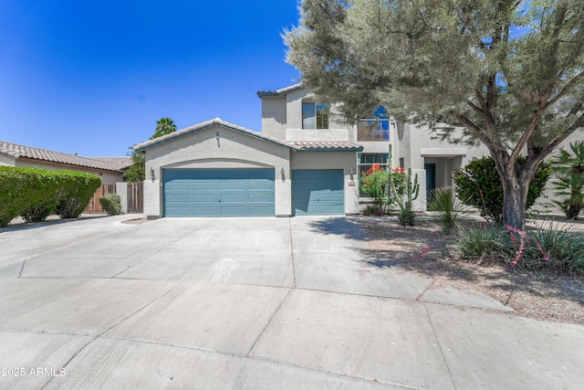 14430 W Windsor Ave, Goodyear, AZ 85395 - mediterranean / spanish-style home featuring stucco siding, driveway, a tiled roof, a garage, and fence