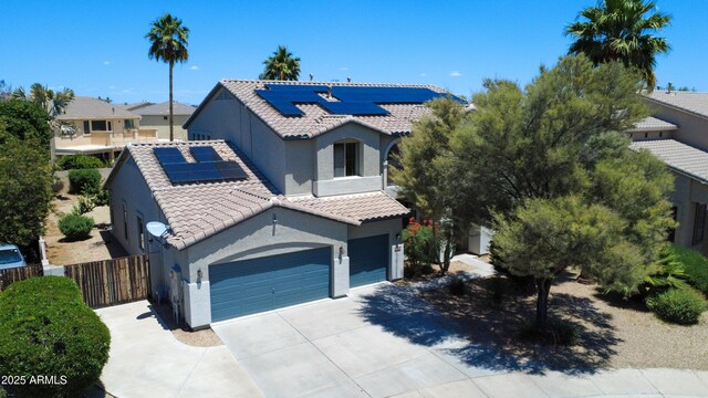 14430 W Windsor Ave, Goodyear, AZ 85395 - view of front of home featuring solar panels, stucco siding, a tiled roof, driveway, and fence
