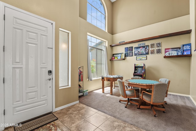 14430 W Windsor Ave, Goodyear, AZ 85395 - carpeted foyer featuring a towering ceiling, baseboards, and tile patterned flooring