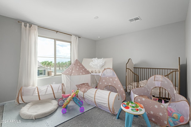 bedroom featuring a nursery area