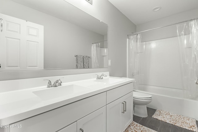 full bathroom with vanity, toilet, shower / bath combo with shower curtain, and hardwood / wood-style flooring