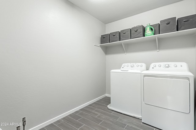 clothes washing area featuring dark hardwood / wood-style flooring and washing machine and dryer