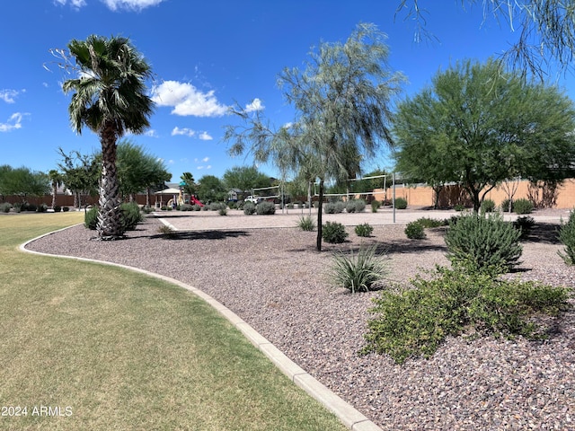 view of community with a lawn and volleyball court