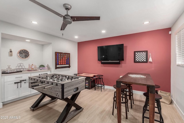 rec room featuring ceiling fan and light wood-type flooring