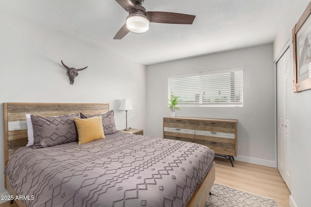 bedroom with light hardwood / wood-style flooring and ceiling fan