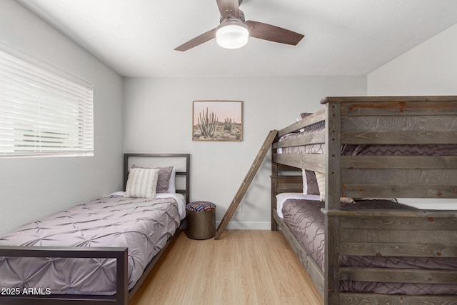 bedroom with light hardwood / wood-style floors and ceiling fan