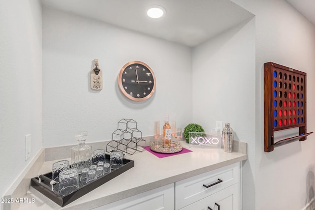 bar featuring white cabinets