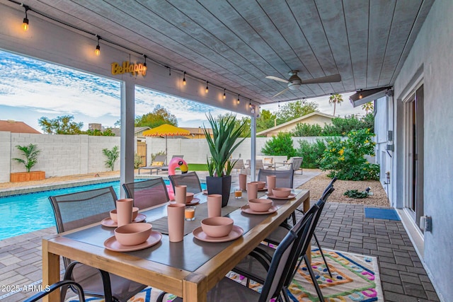 view of patio / terrace with a fenced in pool and ceiling fan