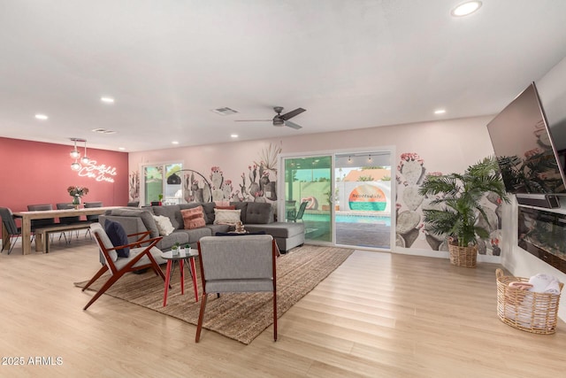 living room featuring ceiling fan and light wood-type flooring