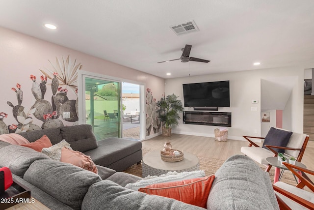 living room with hardwood / wood-style floors and ceiling fan