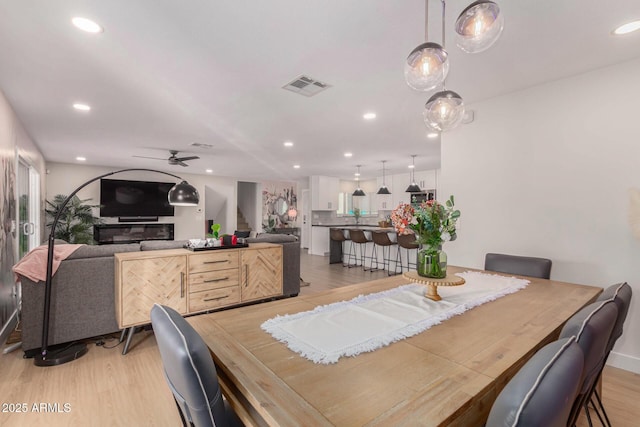 dining space featuring ceiling fan and light hardwood / wood-style flooring