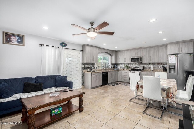 kitchen featuring a ceiling fan, gray cabinets, appliances with stainless steel finishes, and light countertops