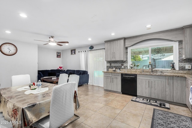 kitchen with a sink, black dishwasher, recessed lighting, decorative backsplash, and light tile patterned floors