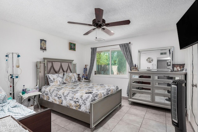 bedroom with a textured ceiling, ceiling fan, and light tile patterned floors