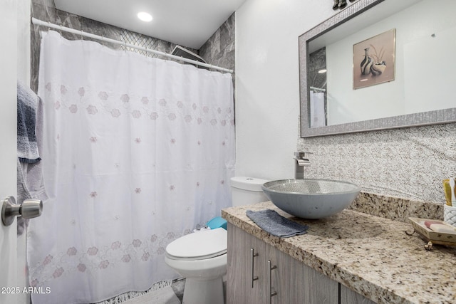 full bathroom with vanity, tasteful backsplash, toilet, and curtained shower