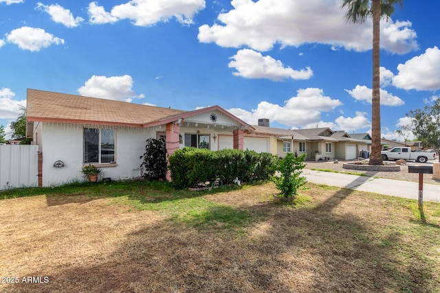ranch-style house featuring concrete driveway, fence, and a garage