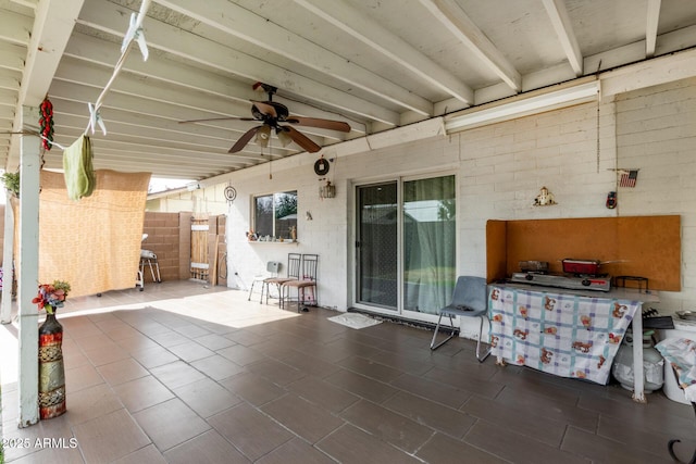view of patio / terrace with ceiling fan and fence