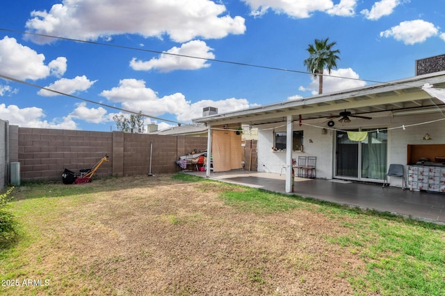 view of yard featuring a fenced backyard, a ceiling fan, and a patio area