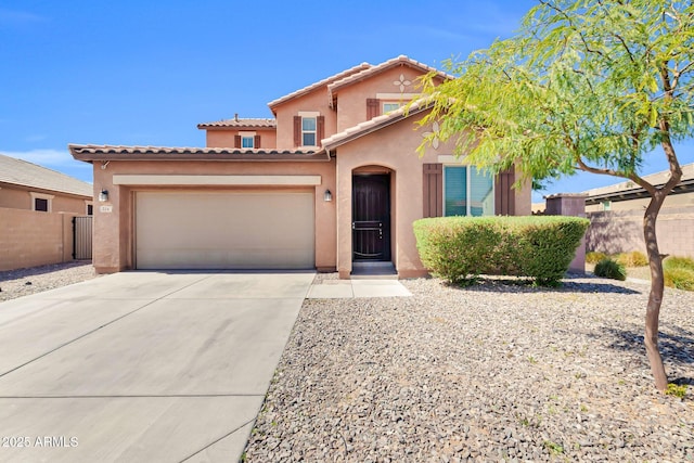 view of front of property featuring an attached garage, fence, driveway, and stucco siding