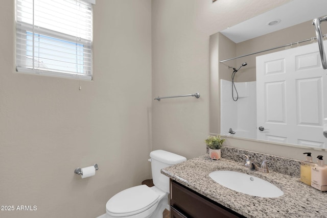 full bathroom with vanity, toilet, and a shower