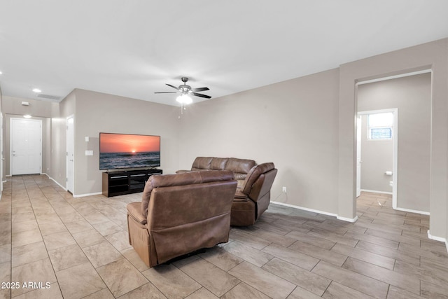 living room with visible vents, ceiling fan, and baseboards