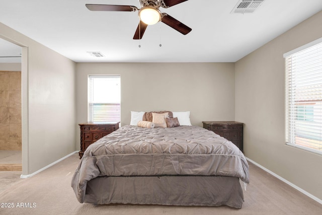 bedroom featuring ceiling fan, light colored carpet, visible vents, and baseboards