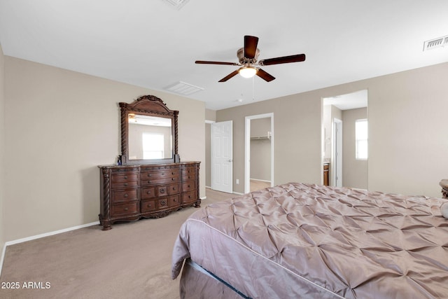 carpeted bedroom with visible vents, multiple windows, and a spacious closet