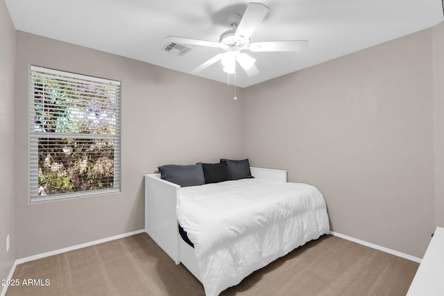 bedroom featuring visible vents, carpet flooring, baseboards, and ceiling fan