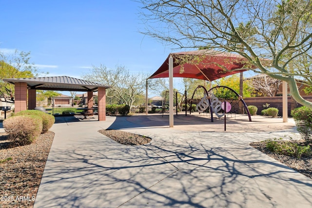 view of property's community with playground community and fence