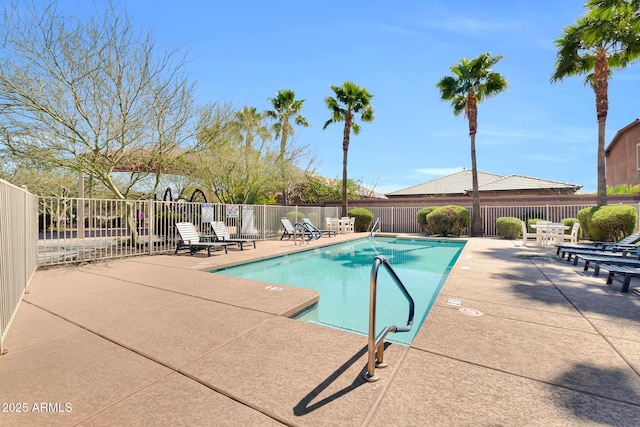 pool with a patio and fence