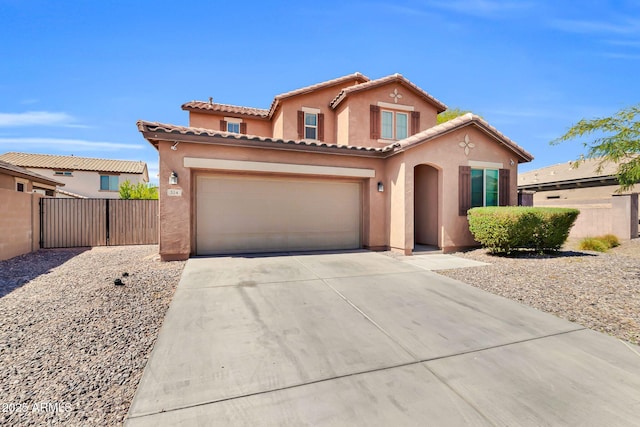 mediterranean / spanish home featuring fence, driveway, stucco siding, a garage, and a tile roof