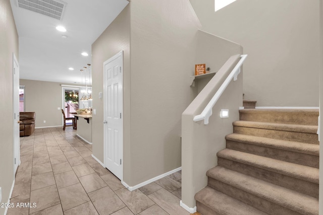 stairs with visible vents, recessed lighting, and baseboards