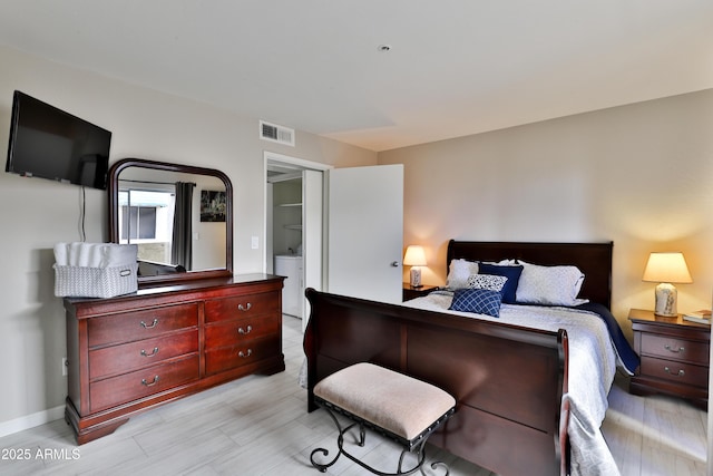 12123 W Bell Rd Unit 218, Surprise, AZ 85378 - bedroom with washer / dryer, baseboards, and visible vents