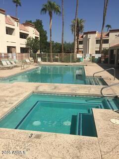 12123 W Bell Rd Unit 218, Surprise, AZ 85378 - pool featuring a patio area, a hot tub, and fence