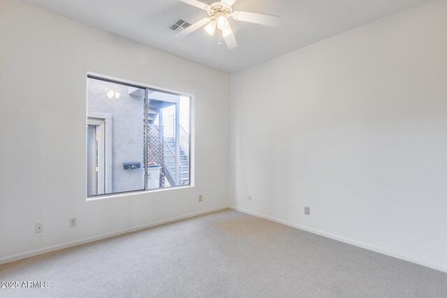 unfurnished room with baseboards, visible vents, ceiling fan, and carpet flooring