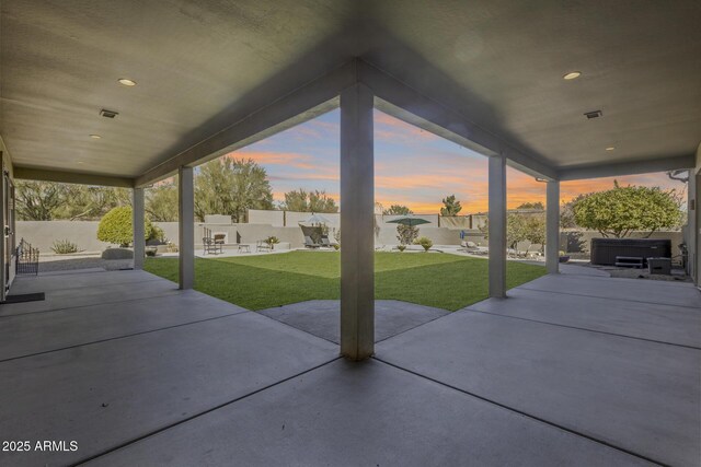 view of patio / terrace featuring a fenced backyard and a hot tub