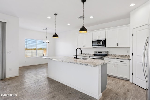 kitchen with appliances with stainless steel finishes, white cabinets, and sink