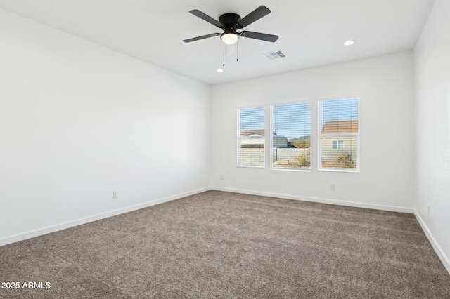 spare room with carpet and ceiling fan