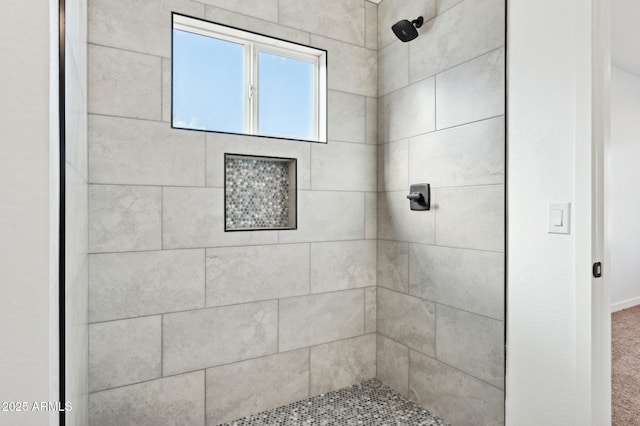 bathroom featuring a tile shower