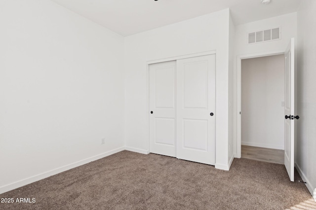 unfurnished bedroom with carpet and a closet