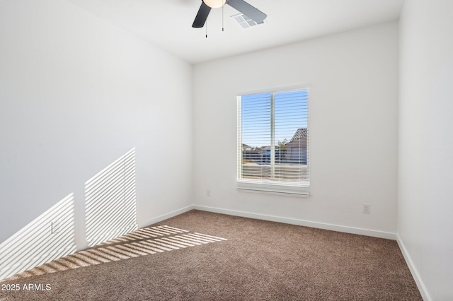 spare room with ceiling fan and carpet