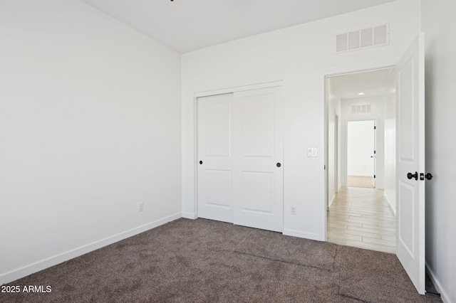 unfurnished bedroom featuring carpet and a closet