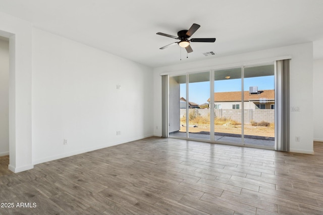 spare room with ceiling fan and a wealth of natural light